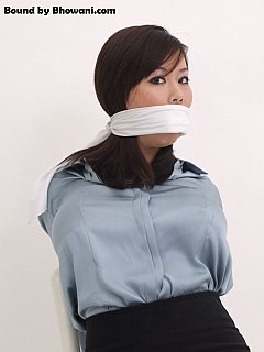 Asian secretary is in bondage, her mouth is stuffed with cloth and she is gagged with a silk scarf