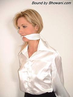 Handcuffed and cleave gagged secretary is wearing perfectly white satin blouse