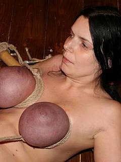 Busty amateur is bound with ropes and bamboo stick