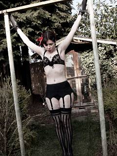 Wife in black lingerie is enslaved and exposed in the backyard