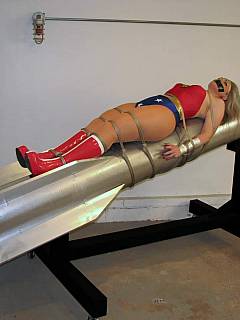 Wonder Woman is in captivity, tied to the rocked and totally helpless