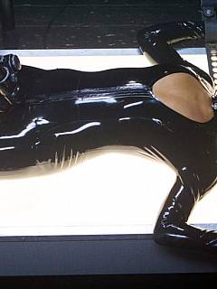 Futuristic fantasy about slut in latex being tortured with BDSM fixtures