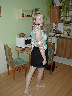 Roped MILF wife is posing for you with a scarf gag in her mouth