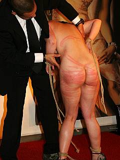 Stripped gal is on stage, bent over the chair and punished in front of a number of spectators