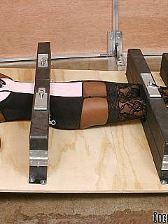 Black slavegirl is restrained with four sets of wooden stocks