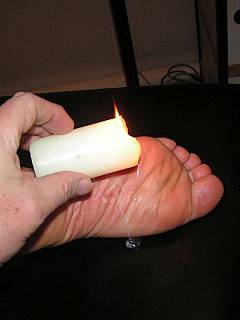 Foot torture: soles are roped and tormented with hot wax