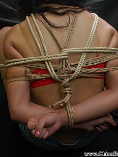 Young Chinese lady is enjoying the ball-tie bondage