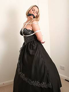 Damsel is becoming tied up wearing posh evening dress