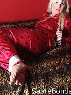 Blindfolded in bed: blonde is in bondage dressed in silk pijama