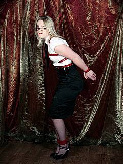 Office worker in having her upper body put in red ropes