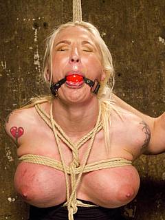 Blonde with silicone tits feels tight ropes around her body and two rubber cocks banging her holes in suspension
