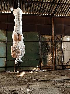 Wrapped in plastic, suspended by her ankles and whipped