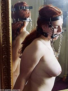 Nude amateur ponygirl is wearing head harness with a gag