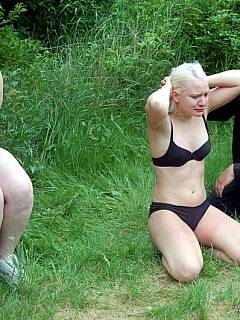 A couple of plumper lesbians are taken outdoors for a kinky BDSM training