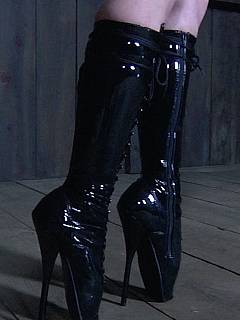 BDSM slut is tormented while wearing high heel ballet shoes, wearing rubber straitjacket and chastity belt