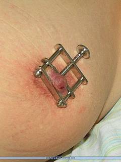 Close-up pictures of mature subgirl having needles in her nipple