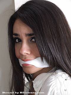 Beautiful face of an office girl captivated with bondage and gagged with cloth