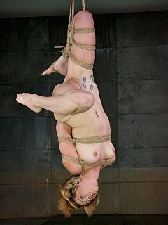 Silly blonde starts her bondage torment dressed up and roped and ends up exposed naked on steel BDSM rack