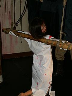 Cruel interrogation of a girl: she is crucified and beaten up by the torturer