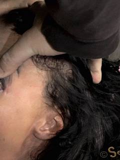 Mouth-fucked slut is left kneeling, bound with leather belts and with cum dripping from her lips
