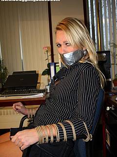 Leggy secretary is chair-tied, tape-gagged and wearing an extremely short skirt