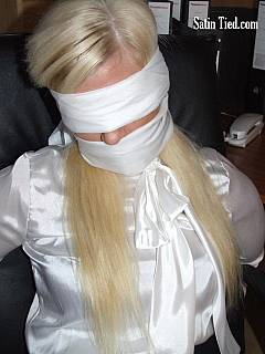 Leggy secretary is tied to chair and wearing tight gag and blindfold made of cloth