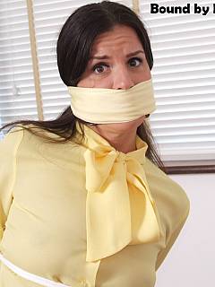 Office damsel looks very frightened after she was tied up and gagged with scarf