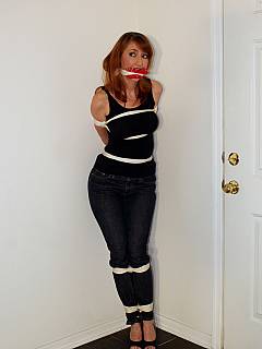 Simple ball-tie makes redhead in jeans totally helpless: she even can't roll or get back into sitting position