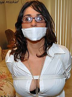 Housewife is looking very sexy after intruder tied her down, gagged and unbuttoned blouse