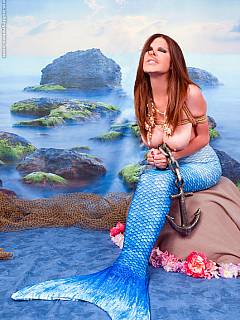 Sexy MILF mermaid is captured with the net and rope-tied afterwards