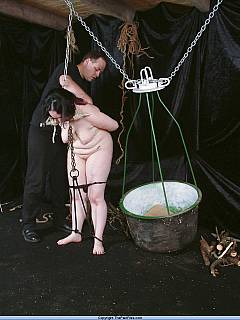 Naked plumper is tit-whipped and restrained with very primitive bondage where chains and ropes are used