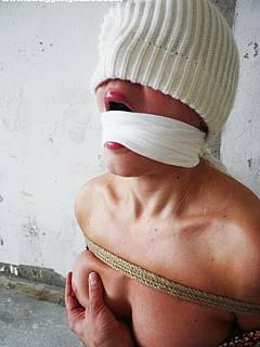 Blindfold, cloth gag and tight restrictive bondage making slim babe feel totally helpless