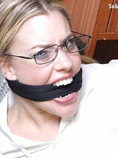 Secretary is trying to fight back when attached by an intruder but loses and ends up in bondage and gagged with cloth