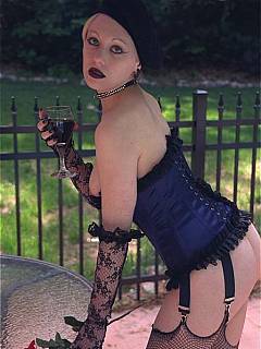 Fetish slut is strolling out on the street dressed up in lingerie, with a glass of wine in her hard and a dildo vibrating in her pussy