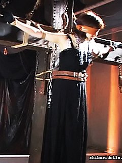 Some perverts are enjoying blindfolded asian girl getting crucified on the BDSM cross