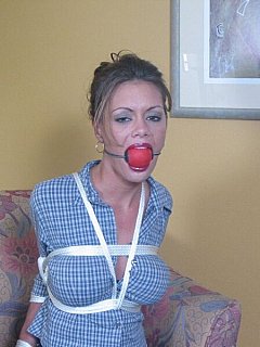 Lovely secretary is suffering from extremely big ball-gag and her elbows tied up behind the back