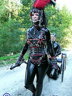 Ponygirl is wearing shiny latex costume for an outdoor ride