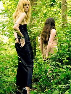 Mistress is walking the handcuffed subgirl on a chain while in the woods