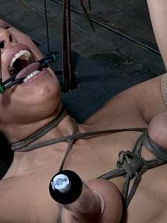Sex slave trainee is having her body contorted with tight rope bondage but gag prevents her from loud screaming