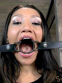 Girl with an exotic look is taught the right way of sucking cock with a ring gag in her mouth