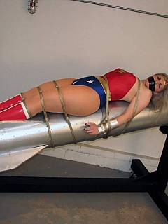 Wonder Woman is in captivity, tied to the rocked and totally helpless