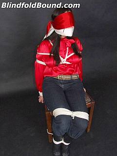 Fully clothed woman in bondage: wearing jeans, gagged and blindfolded with cloth