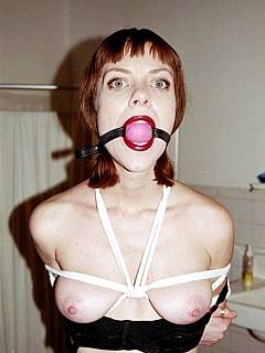 Taming redhead with bondage, ball gag, tit clams and a blindfold
