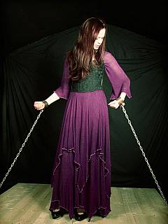 Bondage model is dressed like in medieval times: shackled with steel