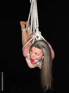 Mature woman is put in suspension while hogtied and ball gagged