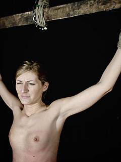 Slim nude is crucified on wooden stick and subjected to nasty whipping