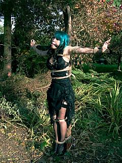Babe with green hair is crucified in the woods