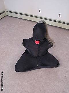 Ball-gagged subgirl is blindfolded and put in a satin body bag