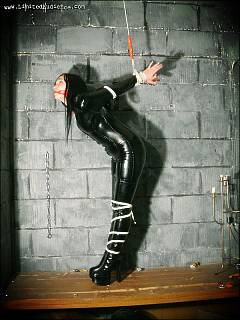 Catwoman is captivated and put in strappado rope bondage