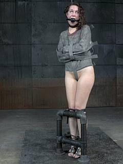 Submission is made easy for her by using chains, leather bondage belts and a straightjacket